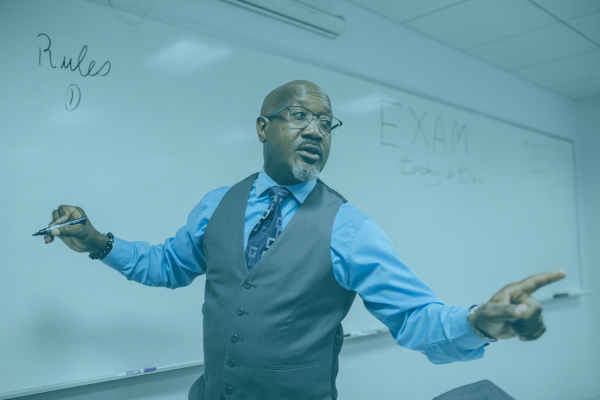 teacher at whiteboard explaining rules