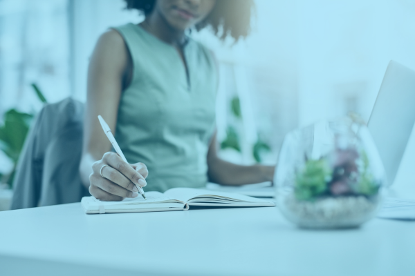 teacher writing in notebook